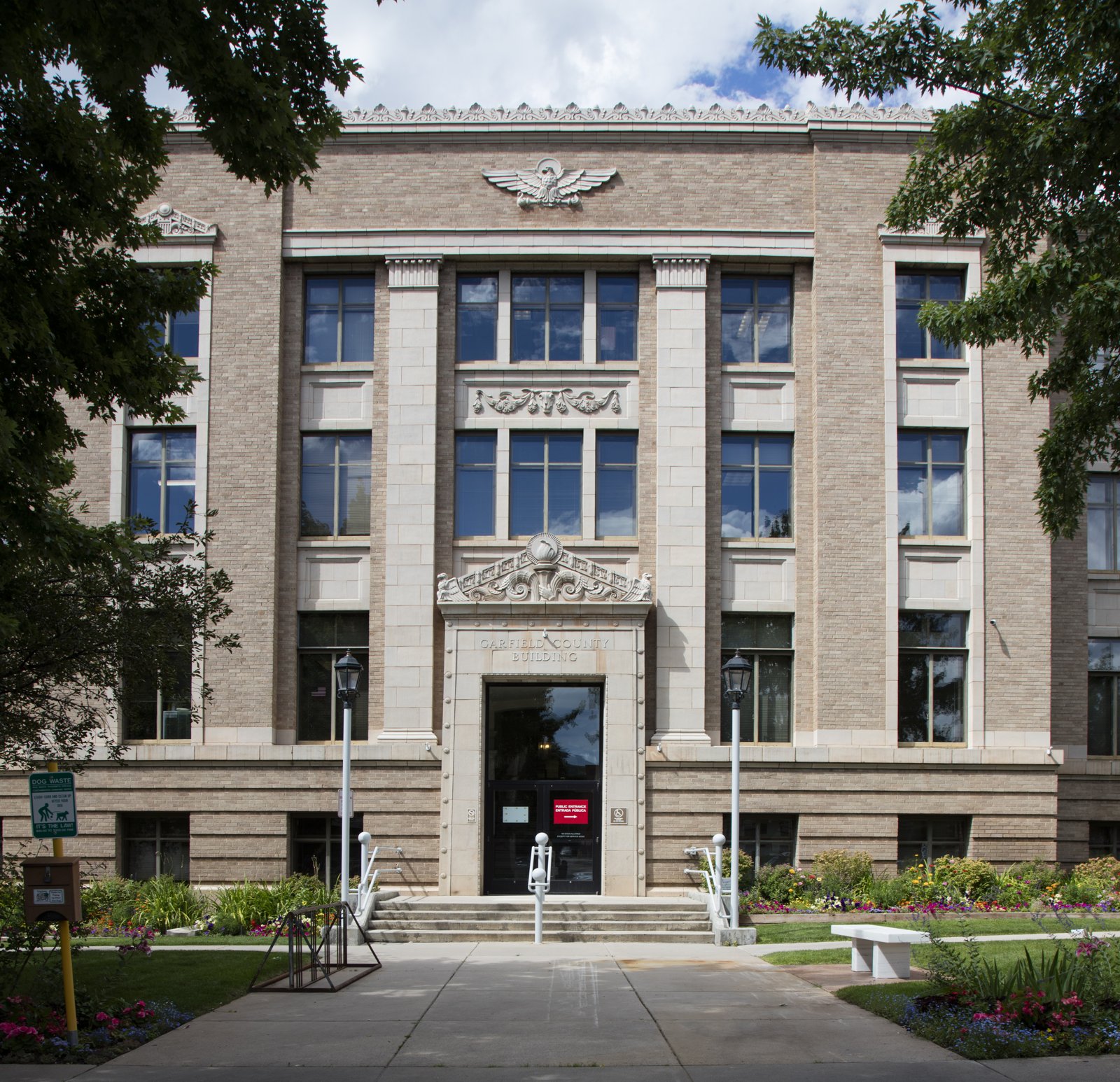 The Garfield County Building in Glenwood Springs, Colorado, a 1920s-style tan stone government building with columns and a carved entrance.
