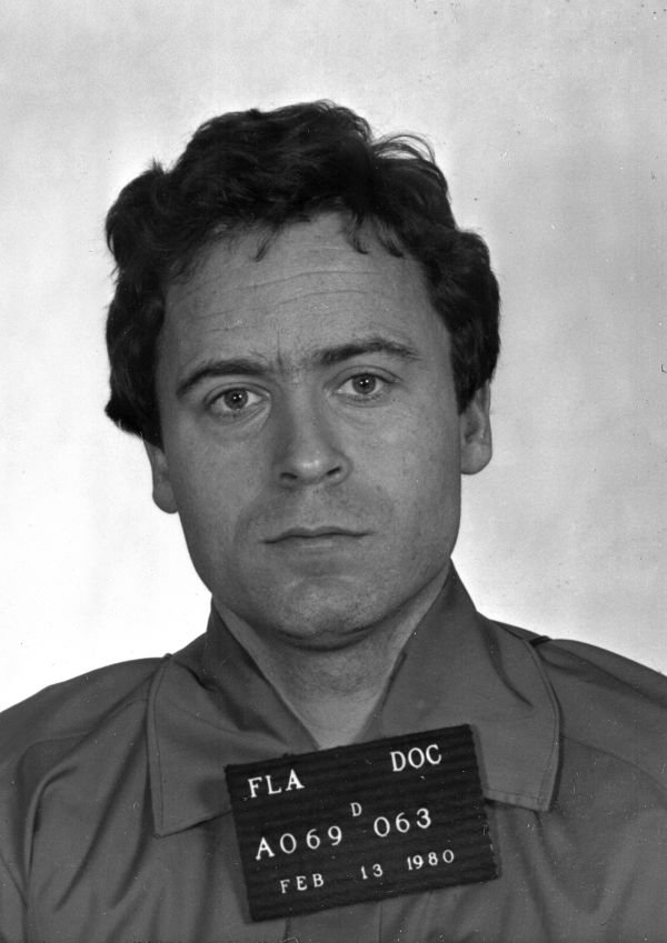 Florida Department of Corrections booking photograph of Theodore Bundy, dated Feb. 13, 1980, holding a placard reading "FLA DOC" with an inmate number.